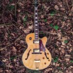 brown and red Epiphone acoustic guitar