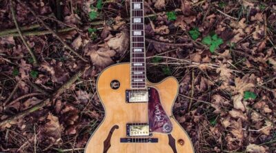 brown and red Epiphone acoustic guitar
