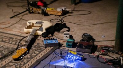 white electric guitar on blue guitar amplifier