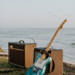 brown and black guitar amplifier on brown wooden dock during daytime