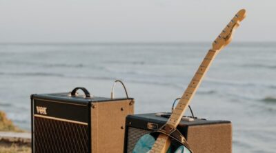 brown and black guitar amplifier on brown wooden dock during daytime