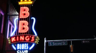 a neon sign on the side of a building